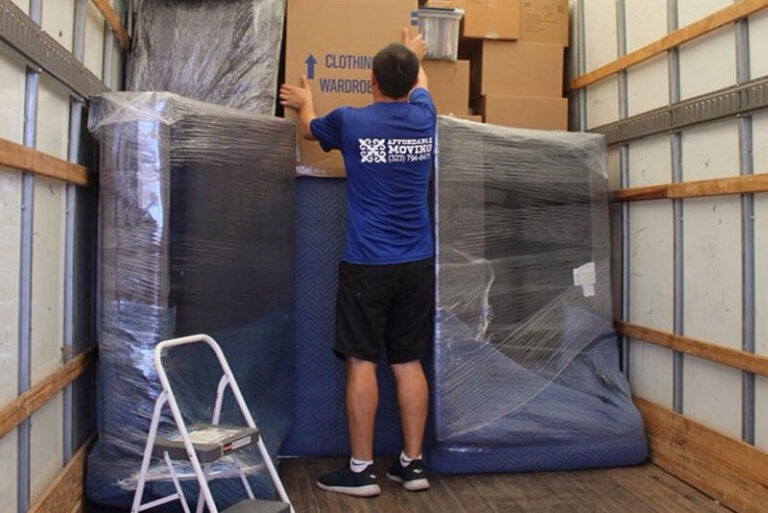 Licensed movers load a two-bedroom apartment for a move.