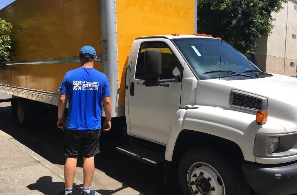 Professional movers load a small apartment into a moving truck.