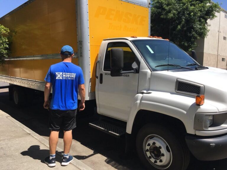 Professional movers load a small apartment into a moving truck.