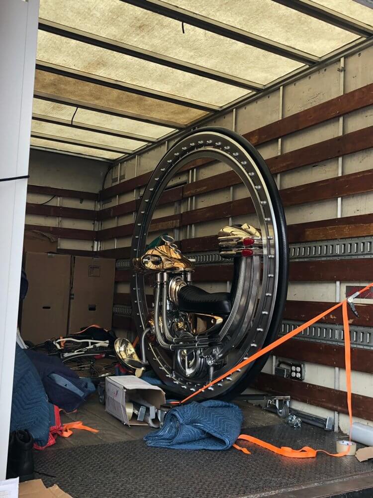 Securely strapped large commercial fitness equipment inside a moving truck during a business relocation