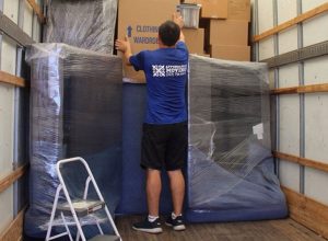 Licensed movers load a two-bedroom apartment for a move.