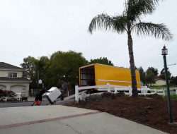 White moving truck driving on a highway, representing university student relocations in Los Angeles